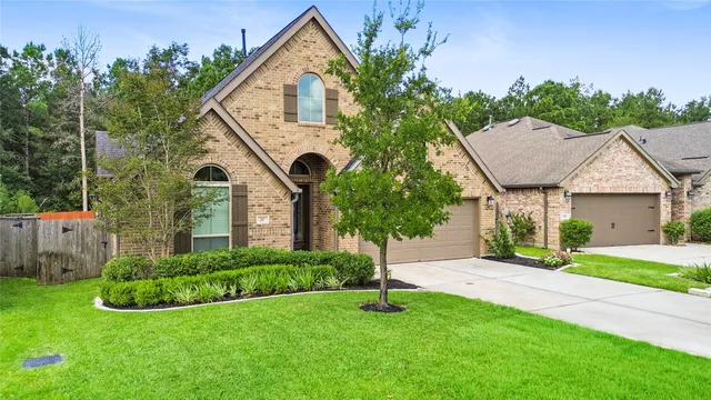 a front view of house with a garden