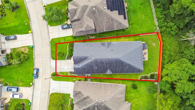 an aerial view of a house with a yard basket ball court and outdoor seating