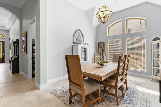 a view of a dining room with furniture wooden floor and a chandelier
