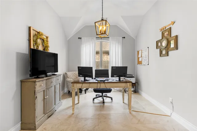 a view of a livingroom with workspace and a window