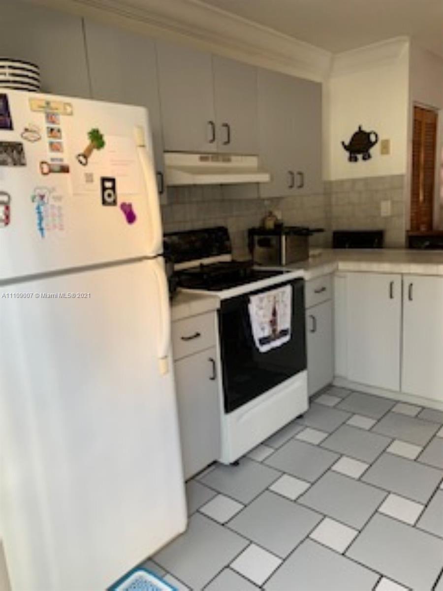 Hialeah Hialeah, FL 33016 - Photo 4 of 8 a white refrigerator freezer and a stove sitting inside of a kitchen