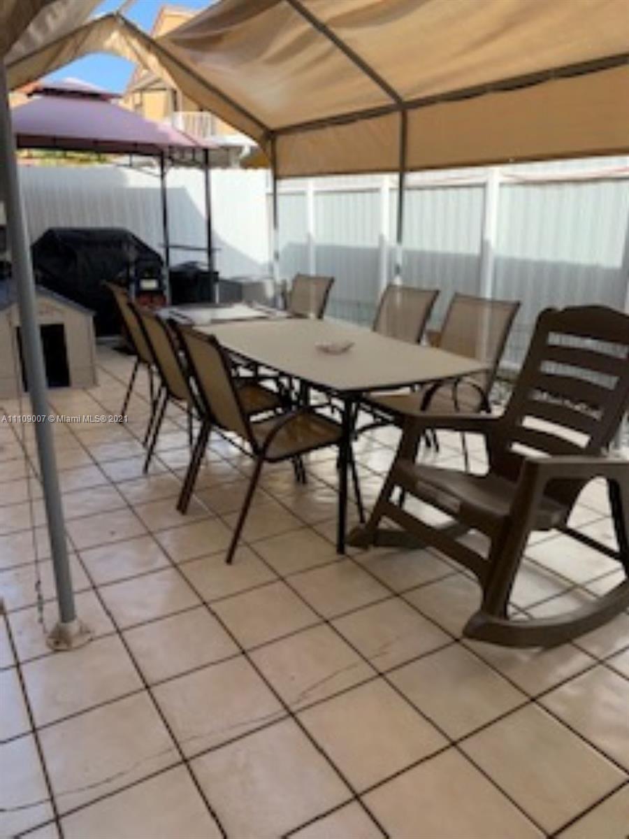 Hialeah Hialeah, FL 33016 - Photo 8 of 8 a view of a patio with a table and chairs under an umbrella
