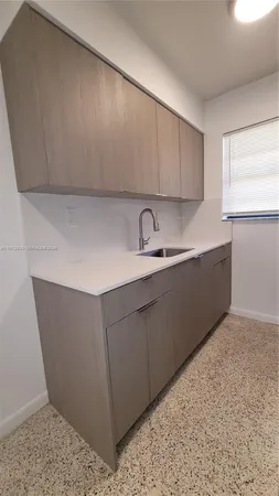 a kitchen with a sink and cabinets