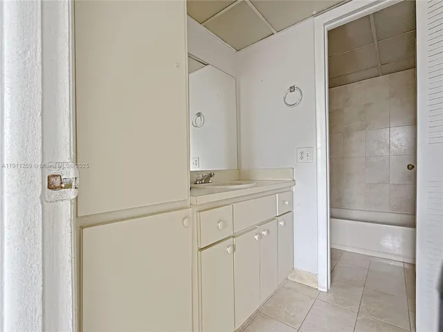 a bathroom with a shower and a mirror