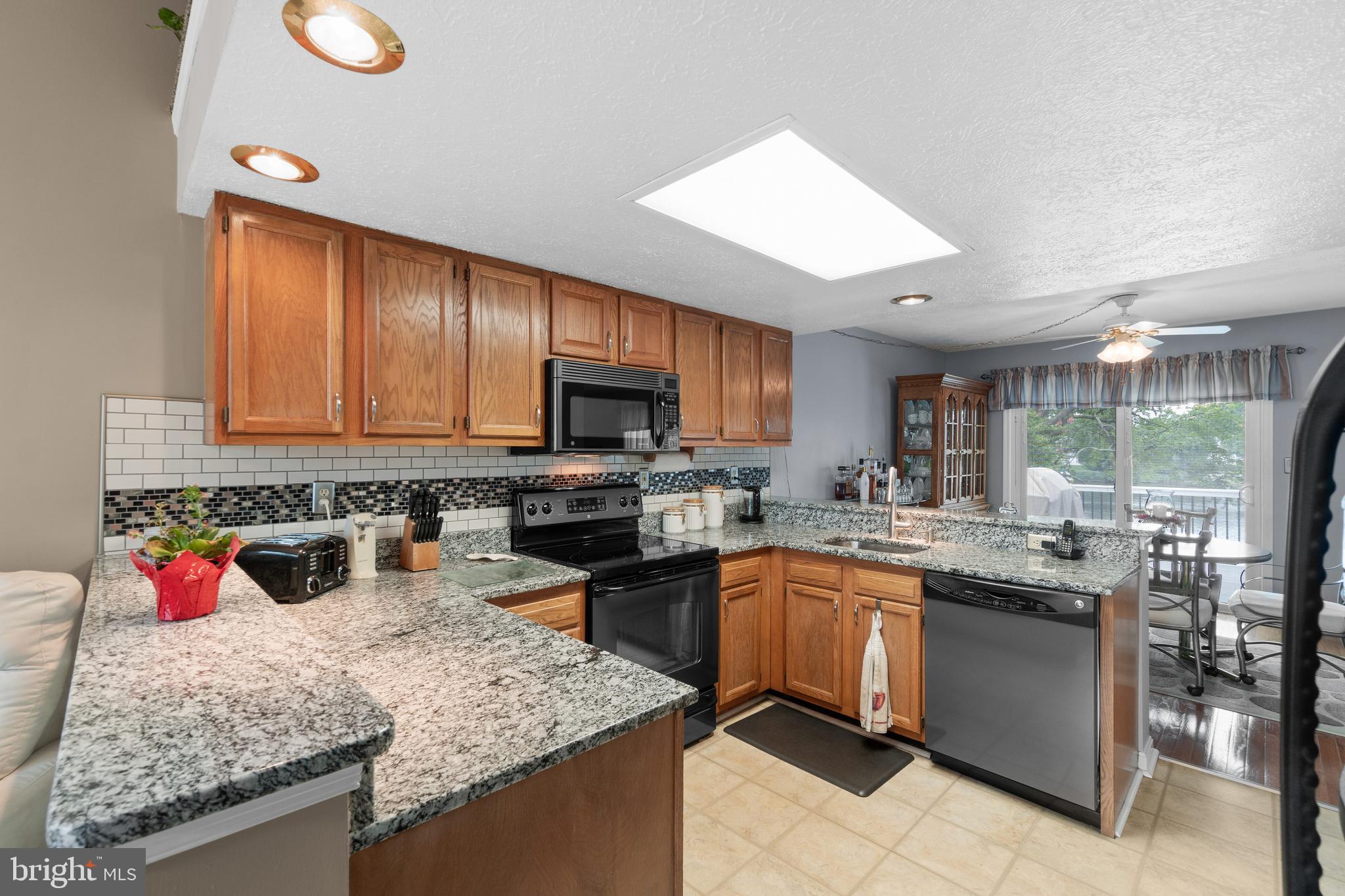 7708 West Shore Road Pasadena, MD 21122 - Photo 9 of 31 Kitchen with granite & stainless steel appliances