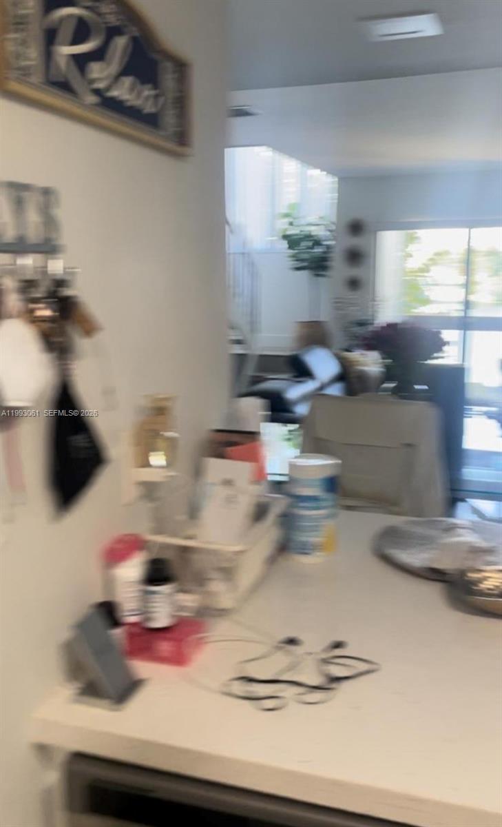 10000 Northwest 9th St Circle, Unit 11 Miami, FL 33172 - Photo 6 of 10 a kitchen with a stove and a white wooden cabinets