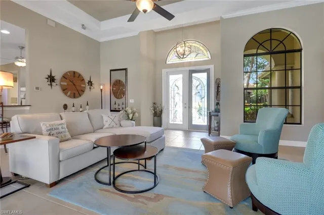 a living room with furniture a window and a chandelier