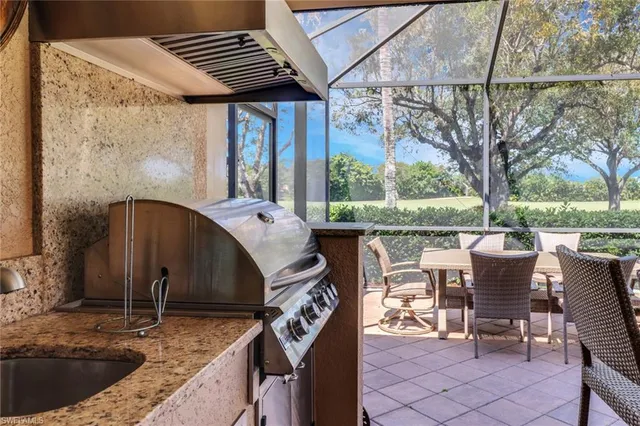 a view of a patio with table and chairs and wooden floor