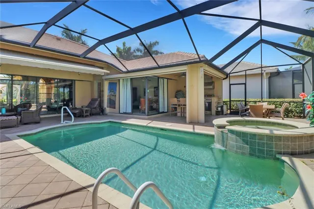 a view of a swimming pool with a patio and a garden