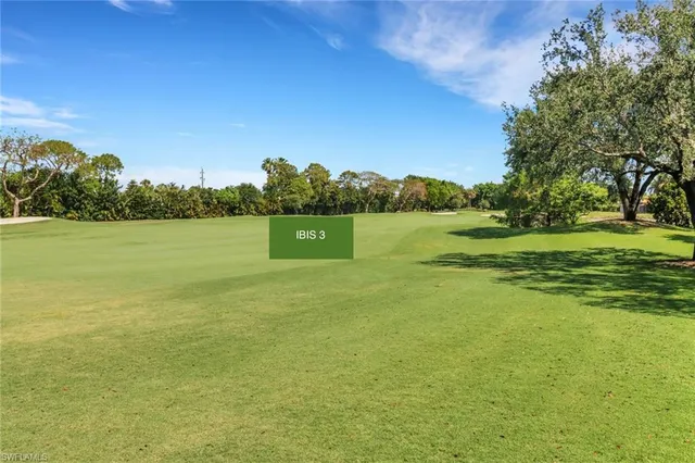 a view of a lake with houses in the back