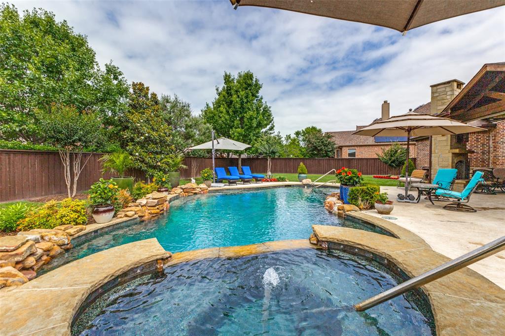 971 Elk Ridge Road Prosper, TX 75078 - Photo 23 of 29 Lush landscaping surrounds this private backyard oasis!