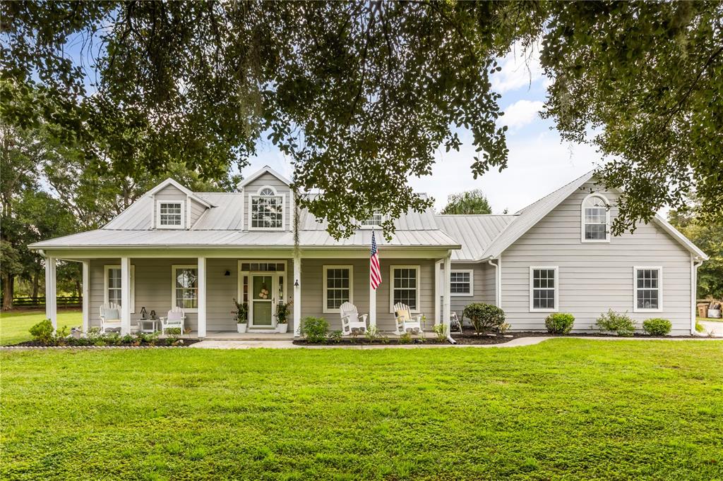 32530 Senese Road Sorrento, FL 32776 - Photo 1 of 34 a front view of a house with a garden