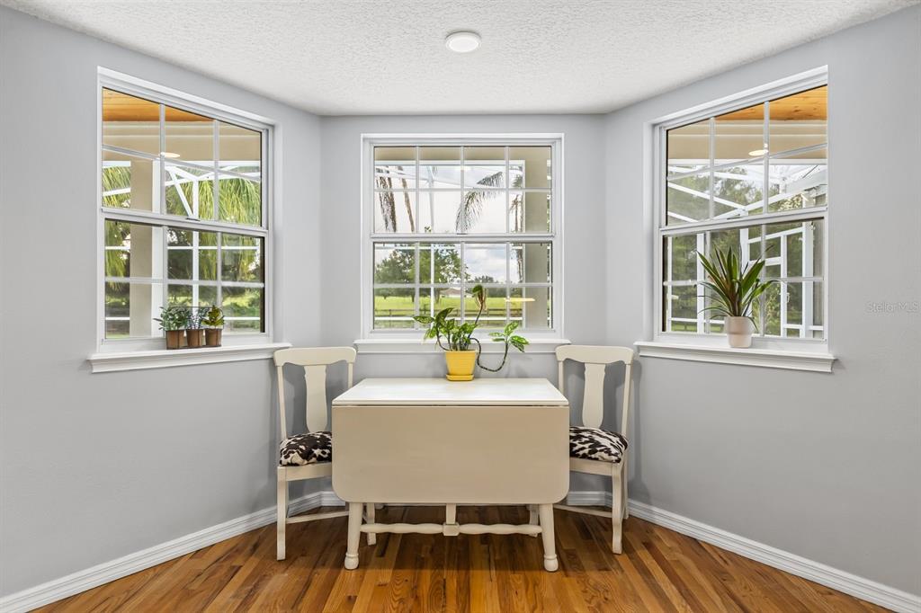 32530 Senese Road Sorrento, FL 32776 - Photo 17 of 34 a dining room with furniture wooden floor and a window
