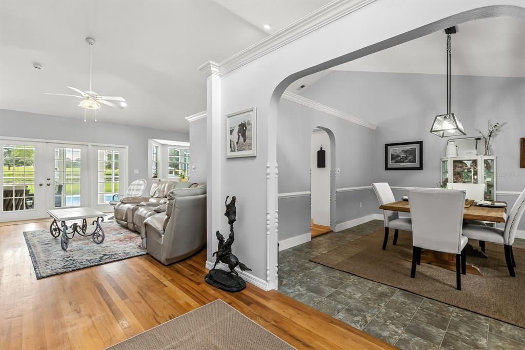 32530 Senese Road Sorrento, FL 32776 - Photo 18 of 34 a living room with furniture a dining table and a chandelier