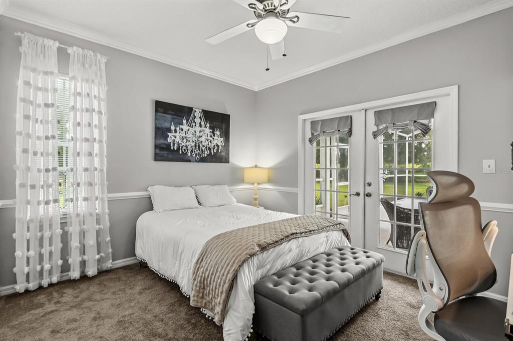 32530 Senese Road Sorrento, FL 32776 - Photo 24 of 34 a bedroom with a bed a chandelier and a window