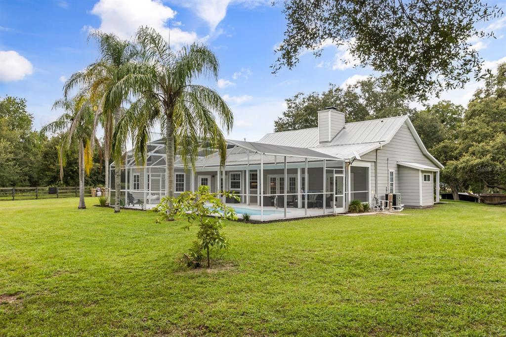 32530 Senese Road Sorrento, FL 32776 - Photo 28 of 34 a view of a house with a big yard and palm trees