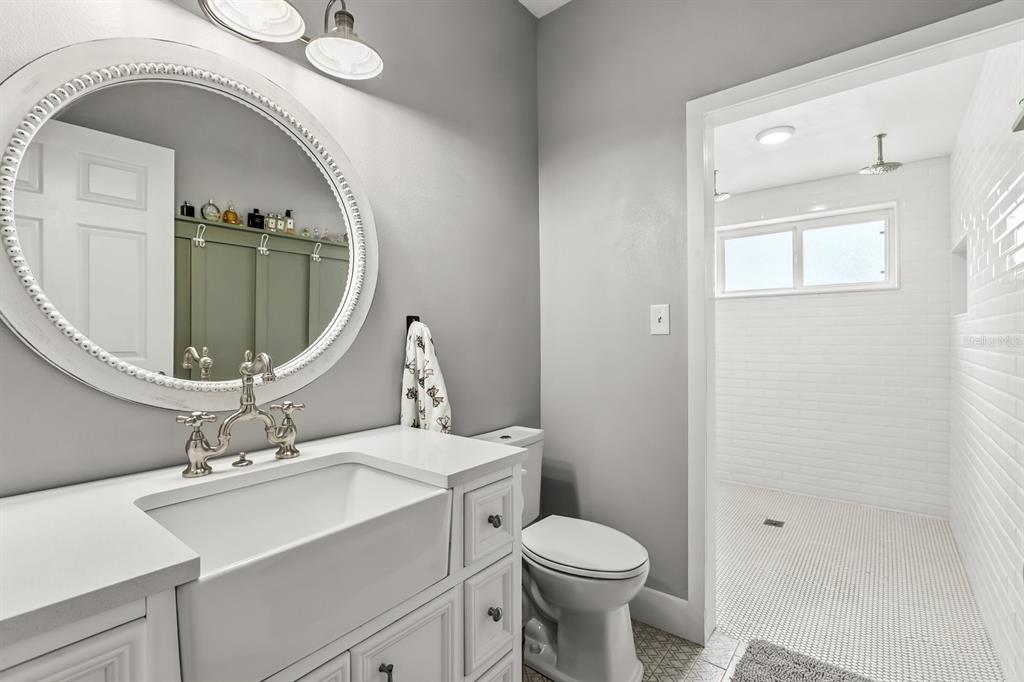 32530 Senese Road Sorrento, FL 32776 - Photo 5 of 34 a bathroom with a sink a toilet and mirror