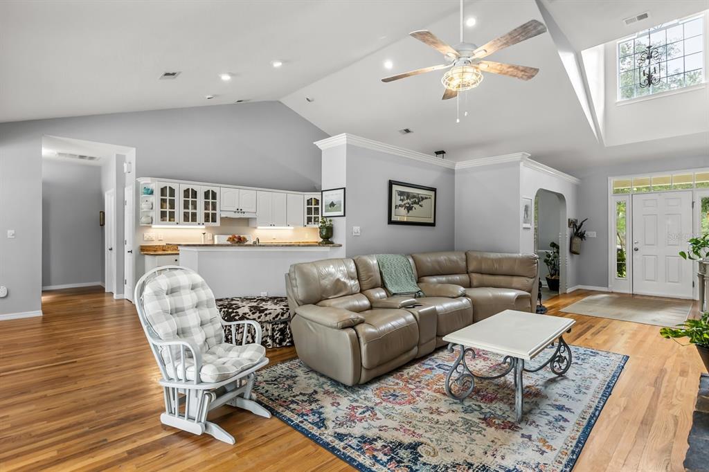 32530 Senese Road Sorrento, FL 32776 - Photo 10 of 34 a living room with furniture and a chandelier