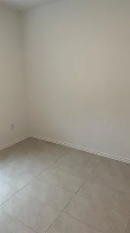 an empty room with a empty space and a window