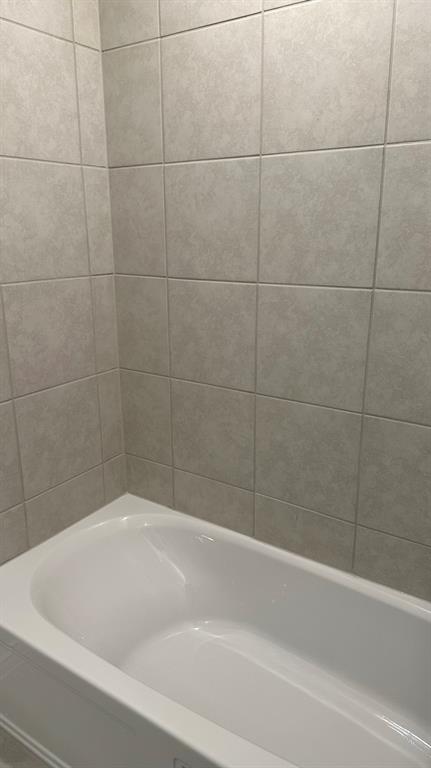 14821 Firerock Road Haslet, TX 76052 - Photo 26 of 35 a bathroom with a bathtub