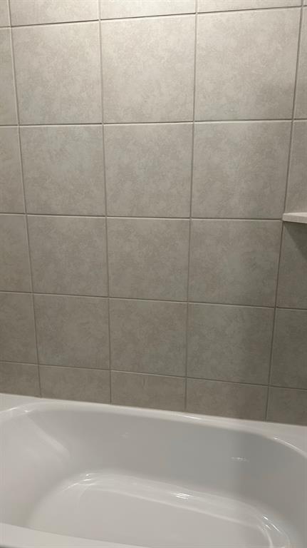 14821 Firerock Road Haslet, TX 76052 - Photo 27 of 35 a bathroom with a bathtub