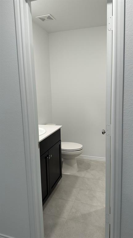 14821 Firerock Road Haslet, TX 76052 - Photo 30 of 35 a bathroom with a toilet and a sink