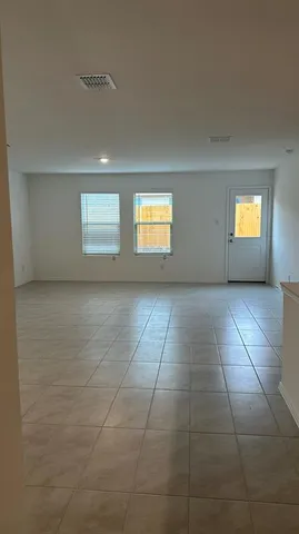 a view of an empty room with a window