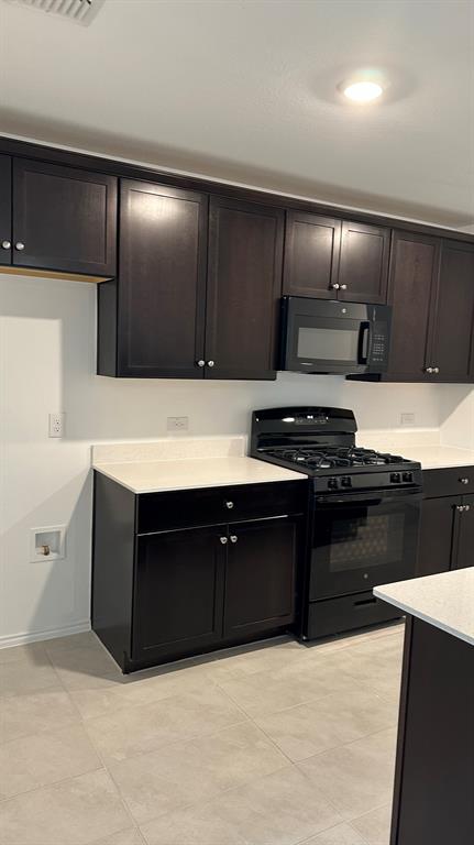 14821 Firerock Road Haslet, TX 76052 - Photo 7 of 35 a kitchen with stainless steel appliances granite countertop a stove a sink and a refrigerator
