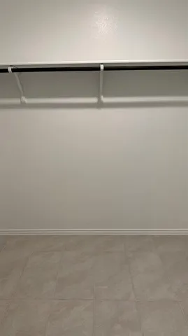 a white toilet sitting next to a small window