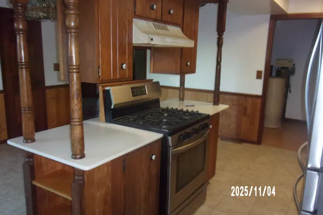a view of a livingroom with wooden floor and staircase