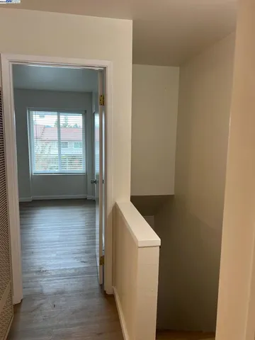 a view of hallway with wooden floor and front door