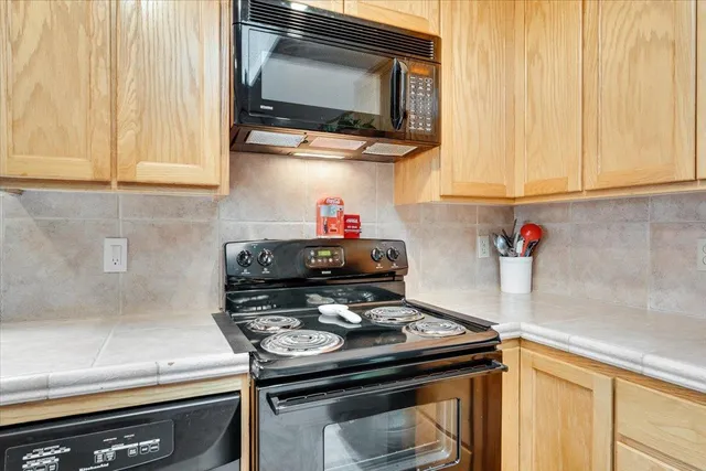a kitchen with a stove and a microwave