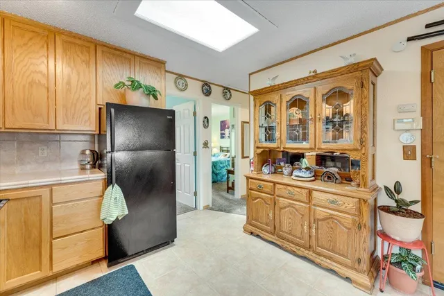 a kitchen with stainless steel appliances granite countertop a refrigerator and a stove