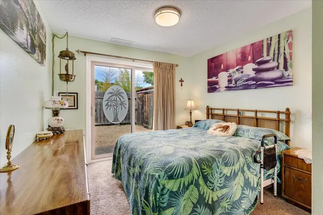 a bedroom with a bed and a painting on the wall