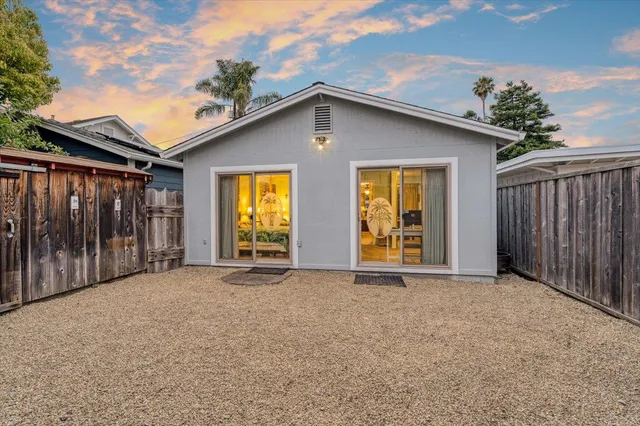 a view of a house with wooden fence