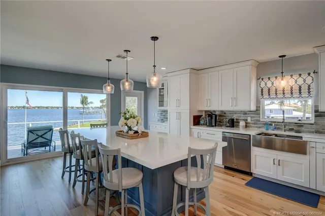 a kitchen with a refrigerator a stove a sink and cabinets