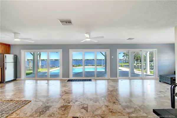 a bedroom with a large bed and a ceiling fan