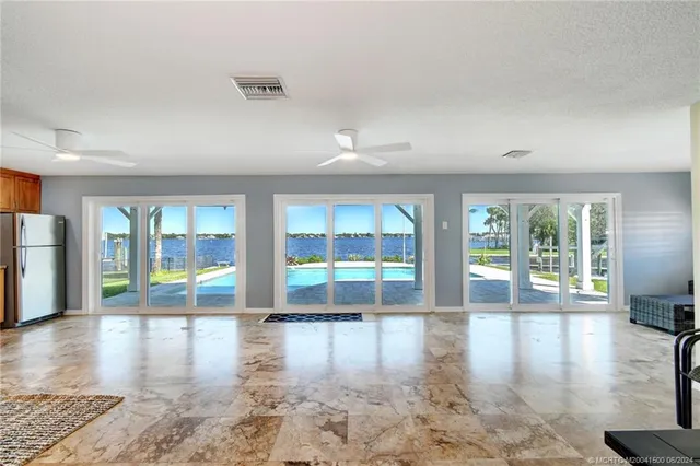 a bedroom with a large bed and a ceiling fan