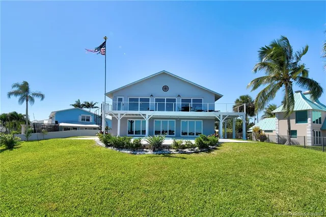 a view of a swimming pool with an outdoor seating and a yard