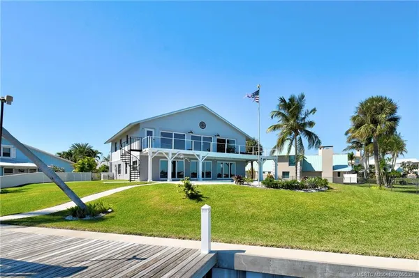 a swimming pool with lawn chairs yard