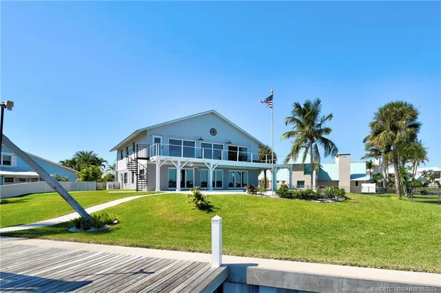 a swimming pool with lawn chairs yard
