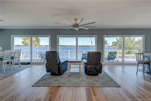 a living room with furniture and large windows