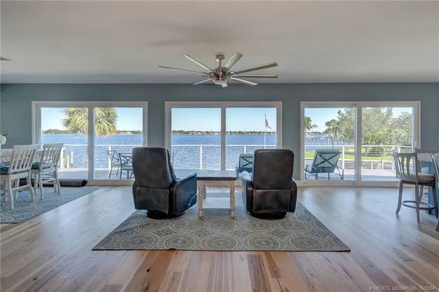 a living room with furniture and large windows