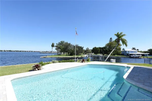 a view of a chairs and table on the balcony