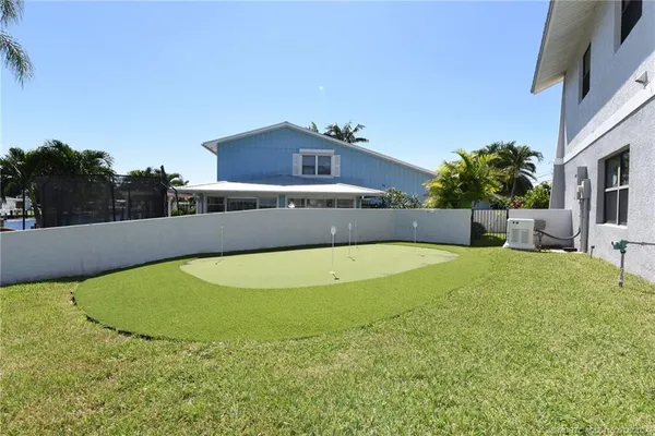 a view of a balcony with chairs and wooden floor