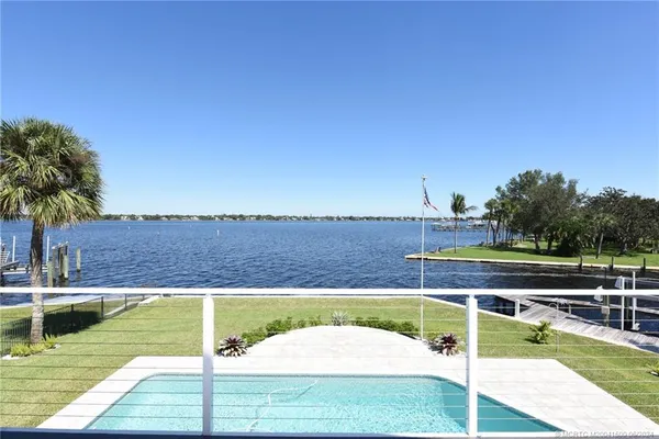 an aerial view of a residential houses with outdoor space and street view