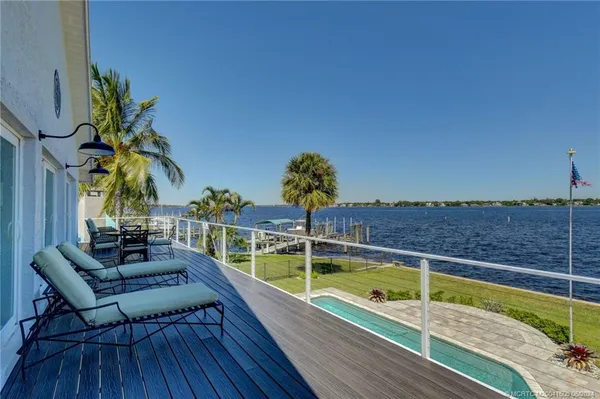 a view of a lake with a table and chairs