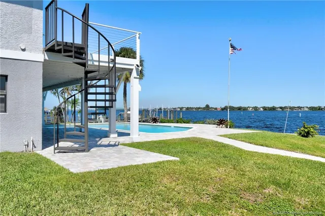 a view of a house with swimming pool and a yard