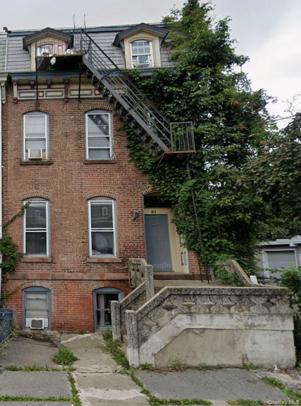 a front view of a house with shrubs