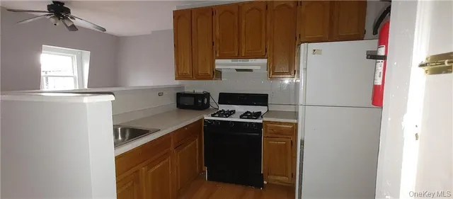 a kitchen with a refrigerator and a stove